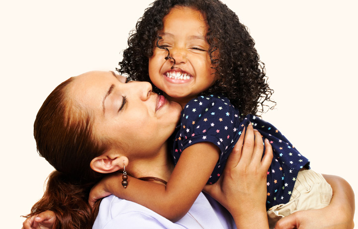 Mom holding healthy happy toddler