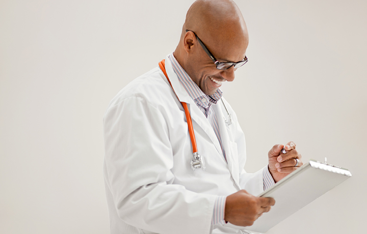 smiling doctor taking notes